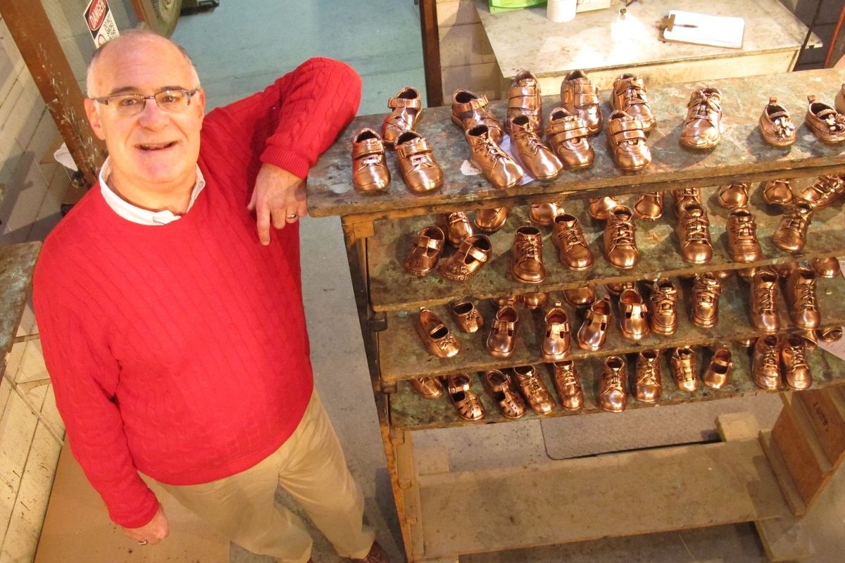 Robert Kaynes, CEO of American Bronzing Co., shows off some of the approximately 100 pairs of baby shoes his company bronzes each day in Columbus, Ohio. Kaynes, the grandson of the company’s founder, says the company bronzed 2,000 shoes a day in the 1970s. (Associated Press)