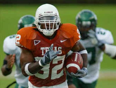 
Texas running back Cedric Benson outdistances a couple of North Texas defenders as he romps for a touchdown during a game earlier this month.
 (Associated Press / The Spokesman-Review)