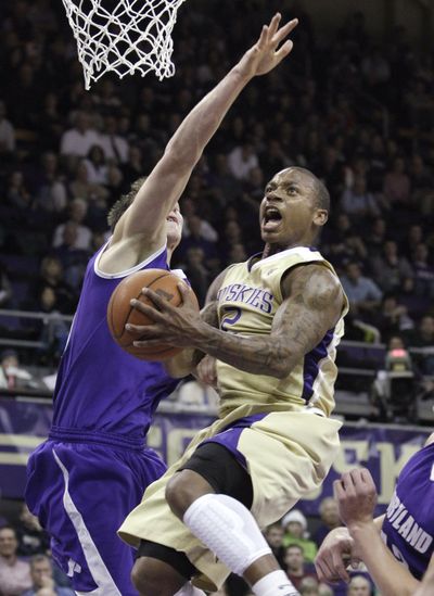 UW’s Isaiah Thomas drives for two against Kramer Knutson. (Associated Press)