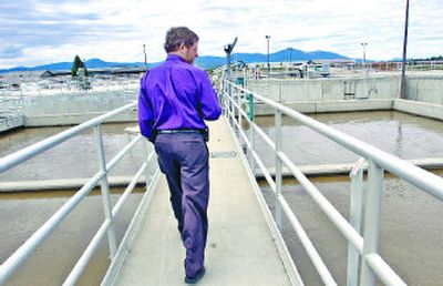 
Terry Werner, public works director for Post Falls, walks across processing tanks April 24 at the  wastewater treatment plant. 
 (Jesse Tinsley / The Spokesman-Review)
