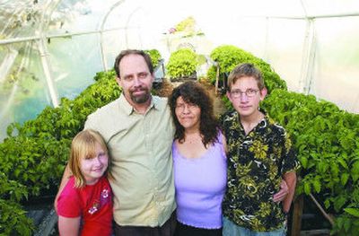 
Master Gardener Elizabeth Casteel has a passion for growing tomatoes – 1,500 this year. She gets plenty of help from her family, including daughter Krystal, 10, husband Steve and son Dave, 13.
 (J. BART RAYNIAK / The Spokesman-Review)