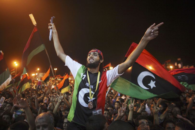 People celebrate the capture in Tripoli of Moammar Gadhafi’s son and one-time heir apparent, Seif al-Islam, at the rebel-held town of Benghazi, Libya, early today. (Associated Press)