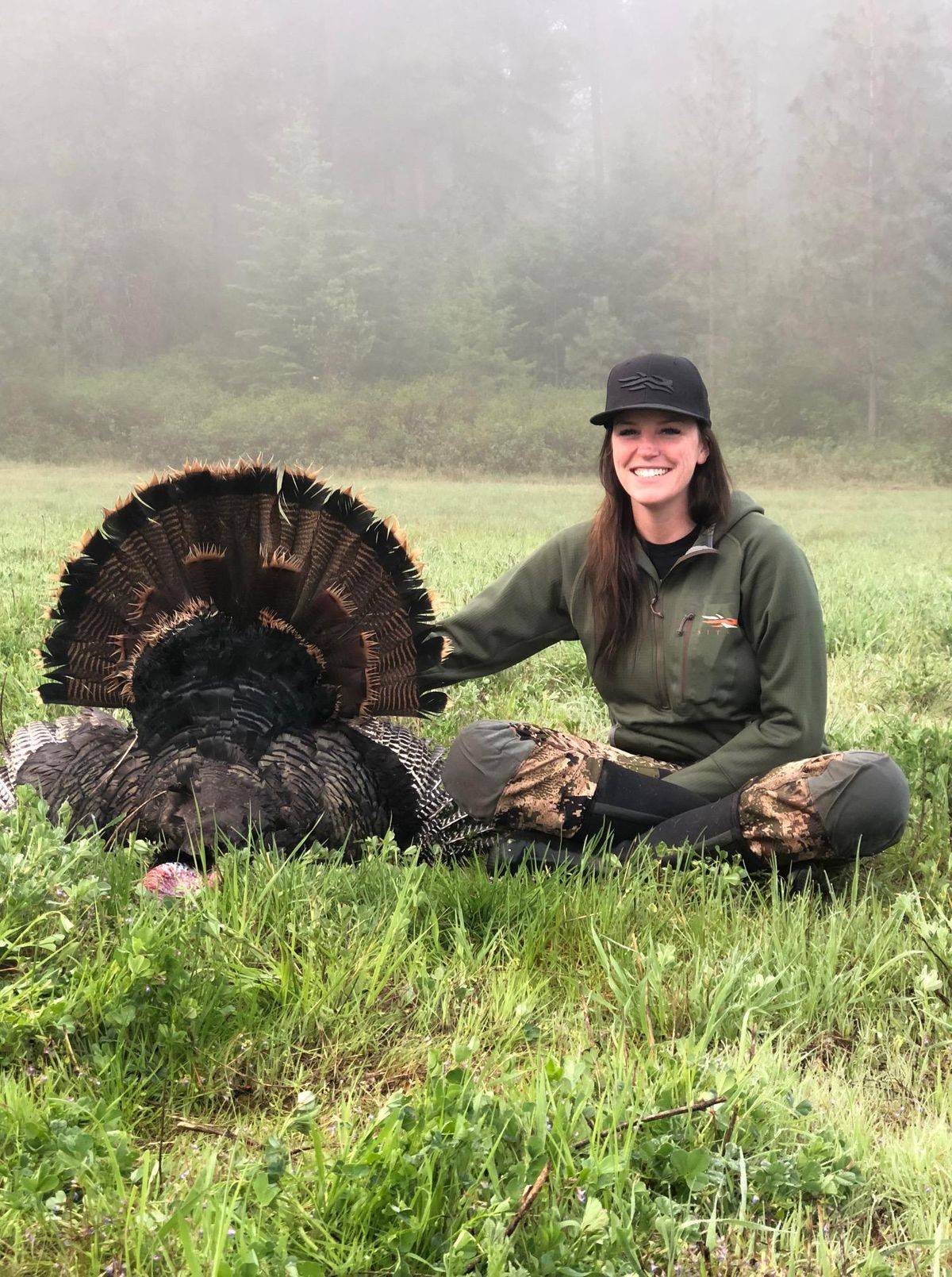 Jamie Belknap poses next to a turkey turkey in Deer Park during the spring of 2018. (Courtesy)