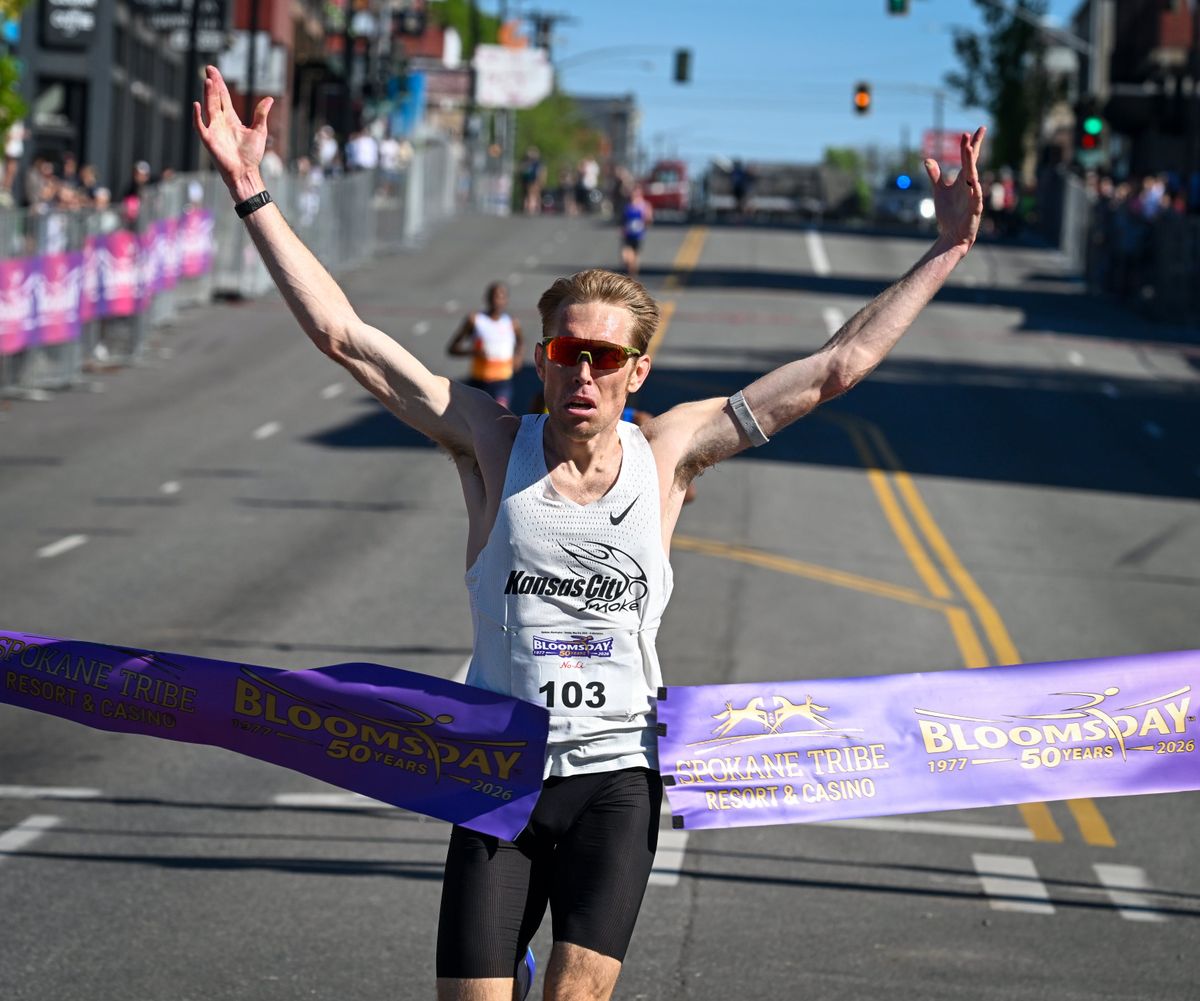 Bloomsday 2026 men’s elite runner Reid Buchanan breaks the tape at the finish line to take first place Sunday in Spokane. Buchanan became the first American man to win the race since 1986.  (Dan Pelle/For the Spokesman-Review)