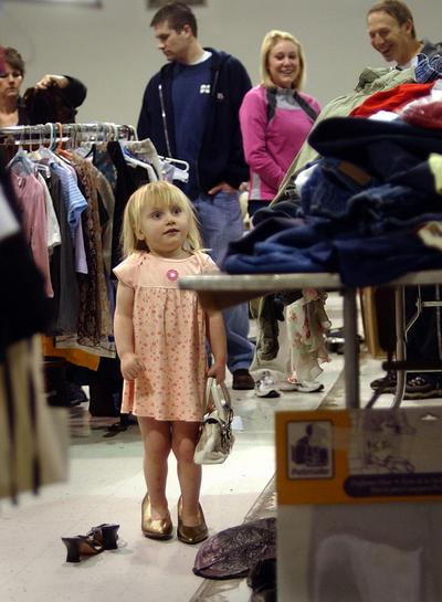 Rose Snyder, 2 1/2, looks for her mother, Hannah, to show off the shoes she found at the Junior League Rummage Sale at the old CompUSA building in Spokane on Saturday.  (Liz Kishimoto / The Spokesman-Review)