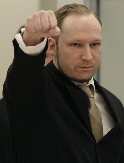 Norwegian Anders Behring Breivik gestures as he arrives at the courtroom in Oslo, Norway, on Tuesday. The anti-Muslim fanatic has admitted to killing 77 people. (Associated Press)