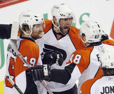 Philadelphia's Daniel Briere (48) celebrates with teammates after scoring against the Montreal Canadiens. Associated Press
(Associated Press / The Spokesman-Review)