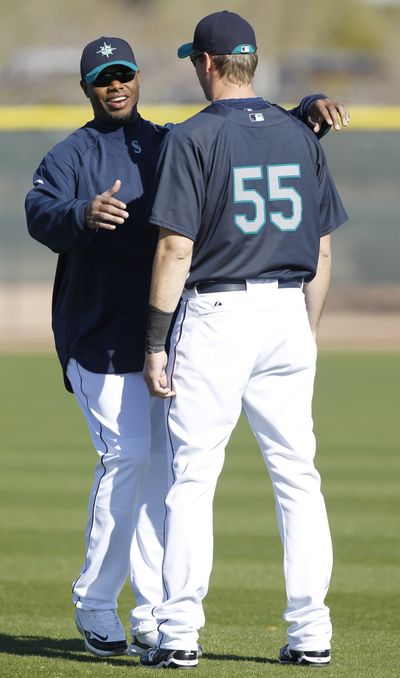 Ken Griffey Jr., left, and Seattle parted ways  with  Michael Saunders, who was sent to Triple-A Tacoma.  (Associated Press)
