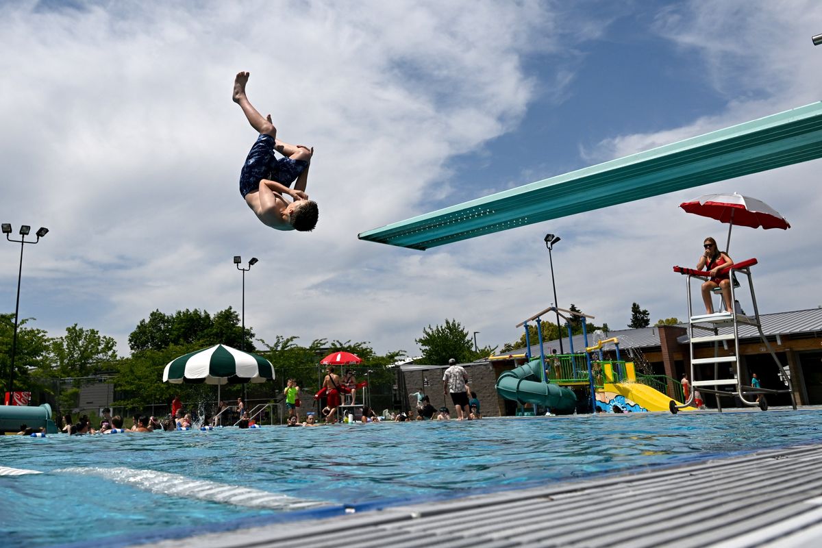 Kamerin Reider, 14, flips into the Shadle Park Aquatics Center pool Tuesday during the afternoon open swim session. (Jesse Tinsley/The Spokesman-Review)