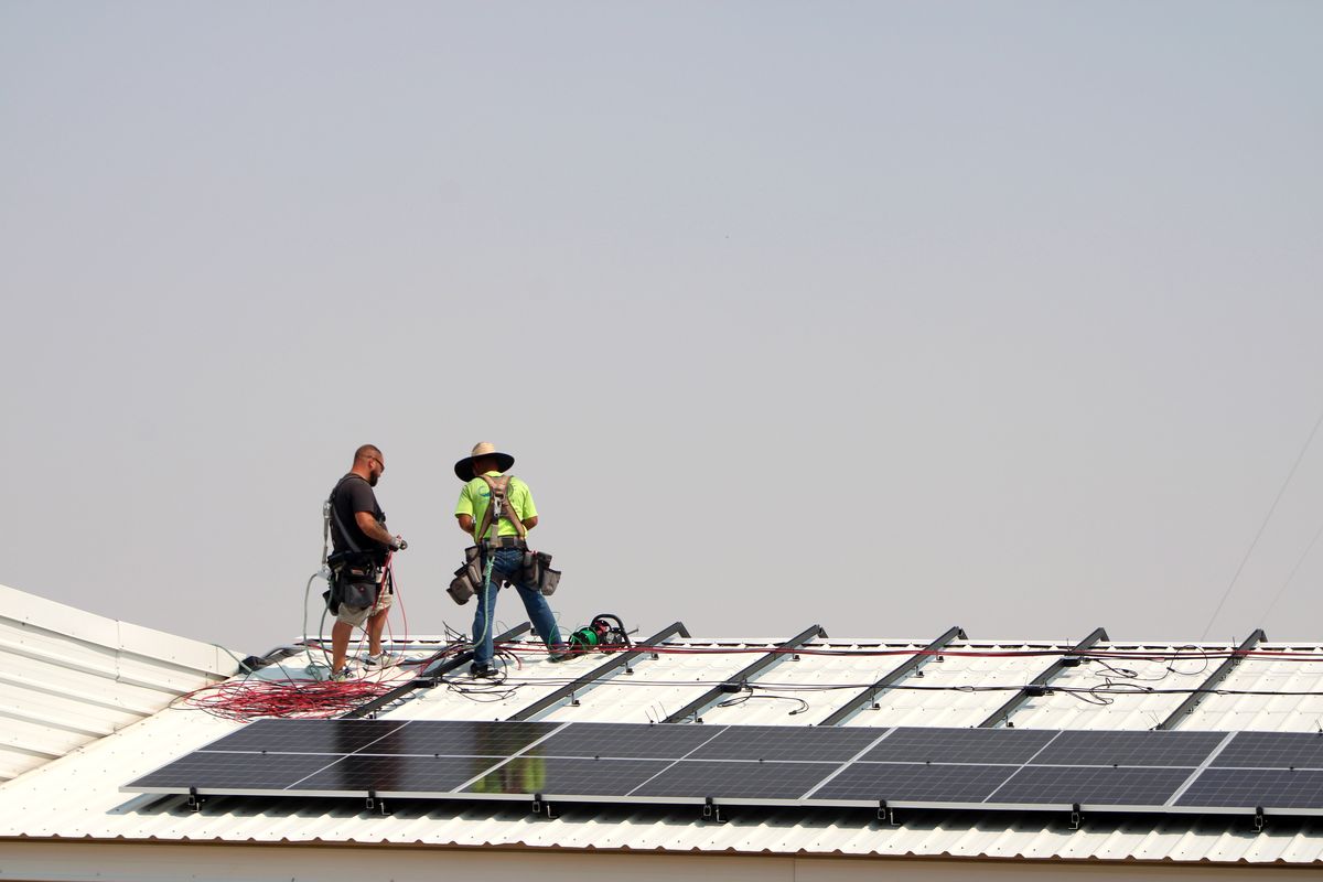 Workers put solar panels in Harrington School District, Aug. 13, 2025. This part of a joint project put together by organizations in Eastern Washington to help rural schools save money. (Monica Carrillo-Casas/The Spokesman-Review)