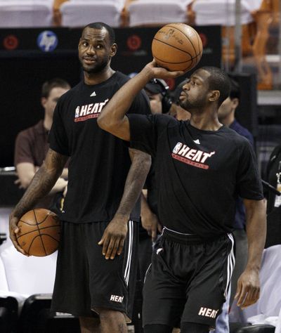 Miami’s LeBron James looks for shooting pointers from Dwyane Wade. (Associated Press)