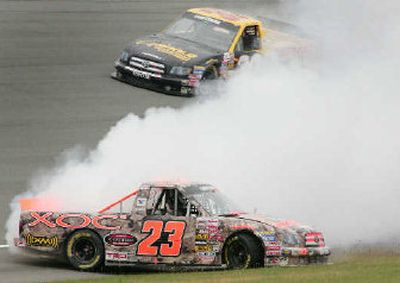 
Johnny Benson (23) spins out in front of Chad Chaffin (30) in Craftsman race. 
 (Associated Press / The Spokesman-Review)
