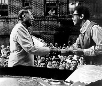In this early 1970s file photo provided by “Jazzmobile,”  Duke Ellington, left, and jazz pianist Billy Taylor shake hands in Harlem.  (Associated Press)