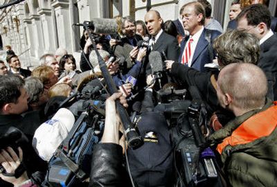 
James Balsillie, center left, co-chief executive of RIM, talks to reporters with attorney Henry C. Bunsow after a federal court hearing Friday in Richmond, Va. 
 (Associated Press / The Spokesman-Review)