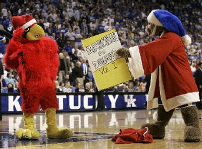 
The Kentucky mascot, right, offers the Louisville mascot Basketball for Dummies during a meeting earlier this season.
 (Associated Press / The Spokesman-Review)