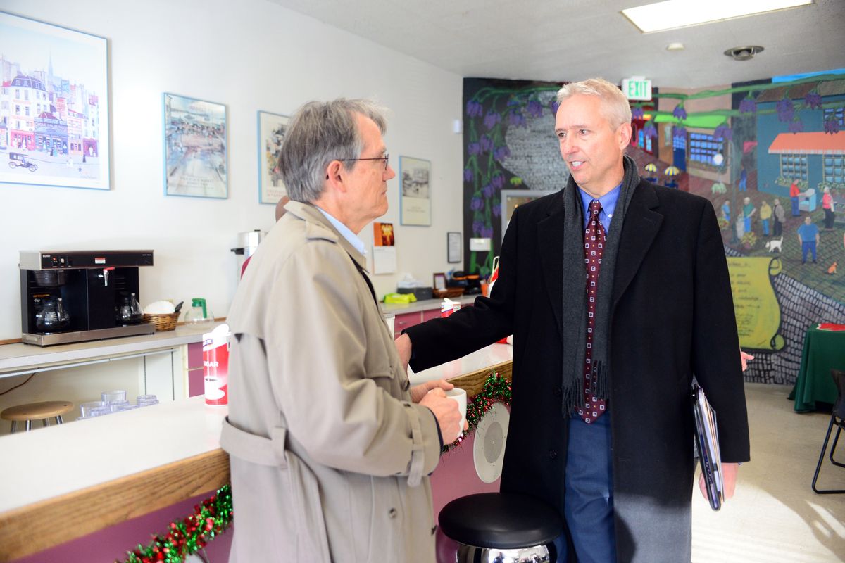 Dr. Tad Patterson, left, and Jeff Thomas, right, talk inside the cafe at the Evergreen Club on East Sprague Avenue on Dec. 6, 2016. The Evergreen Club is a gathering place for members who have been through treatment by Frontier Behavioral Health, a mental illness clinic, which broke ground that day on a new center next door. Patterson at the time was a psychiatrist at Frontier and chairman of the organization's board.   (JESSE TINSLEY/The Spokesman-Review)