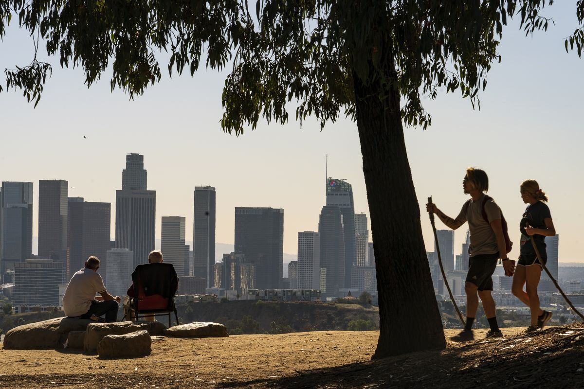 People overlook the skyline of Los Angeles on Jan. 11. California is losing a U.S. House seat for the first time, dropping its delegation from 53 to 52 members. That’s according to Census Bureau population data released Monday that determines how the nation’s 435 House seats are allocated.  (Damian Dovarganes)