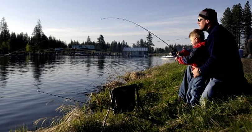 With one giant fish in the bag, three year old Jacksen (cq) and his dad Mike Kaiser try to land another trout at West Medical Lake early on the opening weekend of Washington's fishing season.  (FILE The Spokesman-Review)