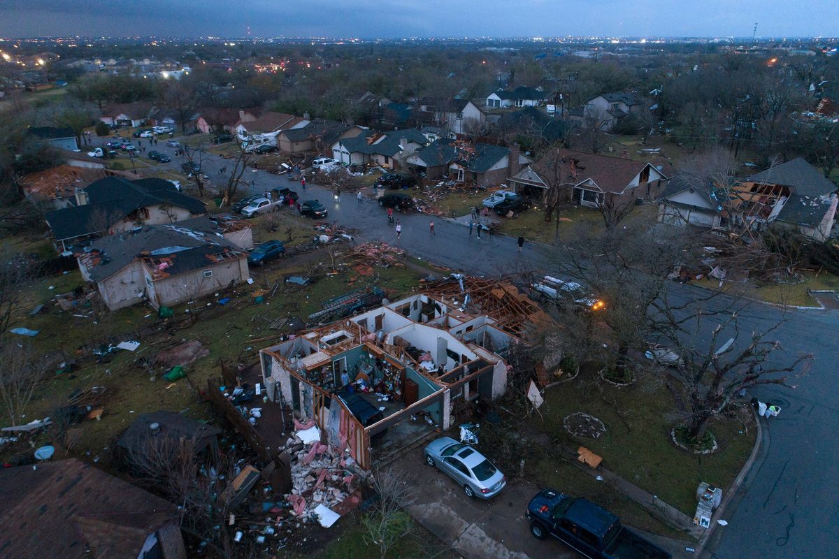 Debris litters the ground surrounding homes, damaged by a tornado, on Oxford Drive and Stratford Drive in Round Rock, Texas Monday, March 21, 2022.  (Jay Janner)