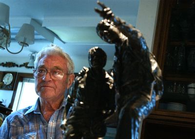 Dean Dinnison is seen here in 2006 with a small version of the statue.  (File / The Spokesman-Review)