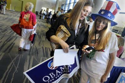 
Patty Elliott, left, and Rose Honsa, both of Spokane County,  check their phones Friday at the Washington State Democratic Convention. 
 (CHRISTOPHER ANDERSON / The Spokesman-Review)
