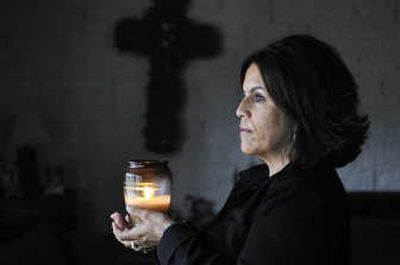 
Lisa Morgan burns a  candle  at her Spokane Valley home in memory of her brother Richard 