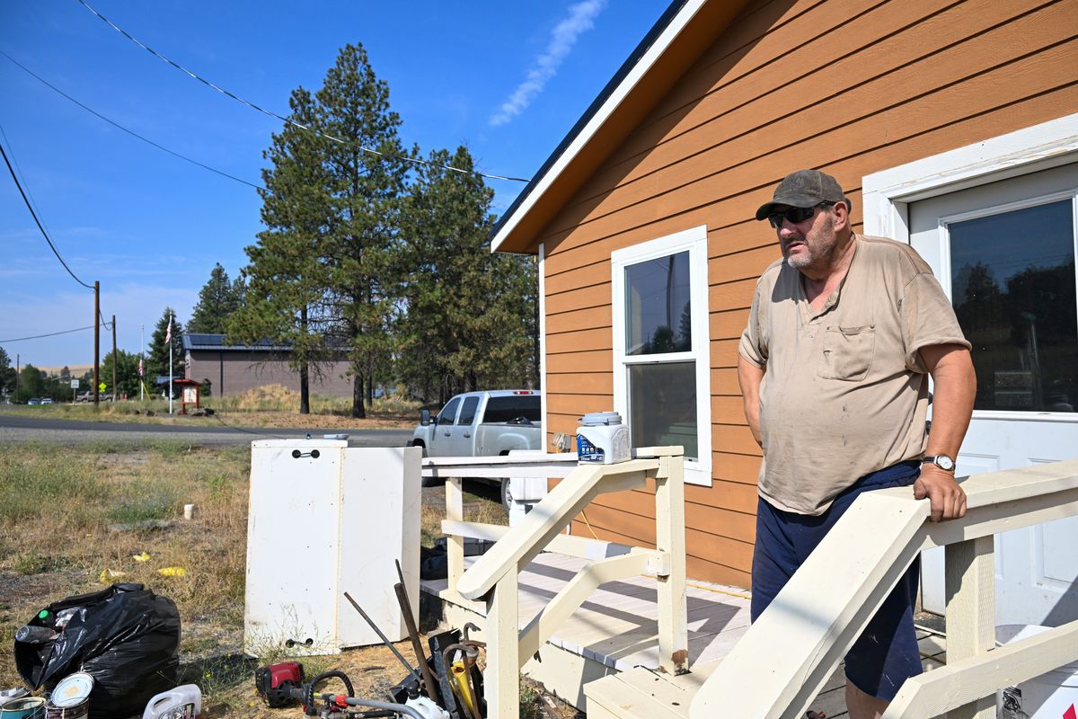 Todd Deckard, 62, stands Thursday on the front porch of the small two-bedroom house built for him by Amish missionaries after his mobile home burned up in the 2020 wildfire that destroyed the town of Malden, Washington on Labor Day five years ago.  (Jesse Tinsley/The Spokesman-Review)