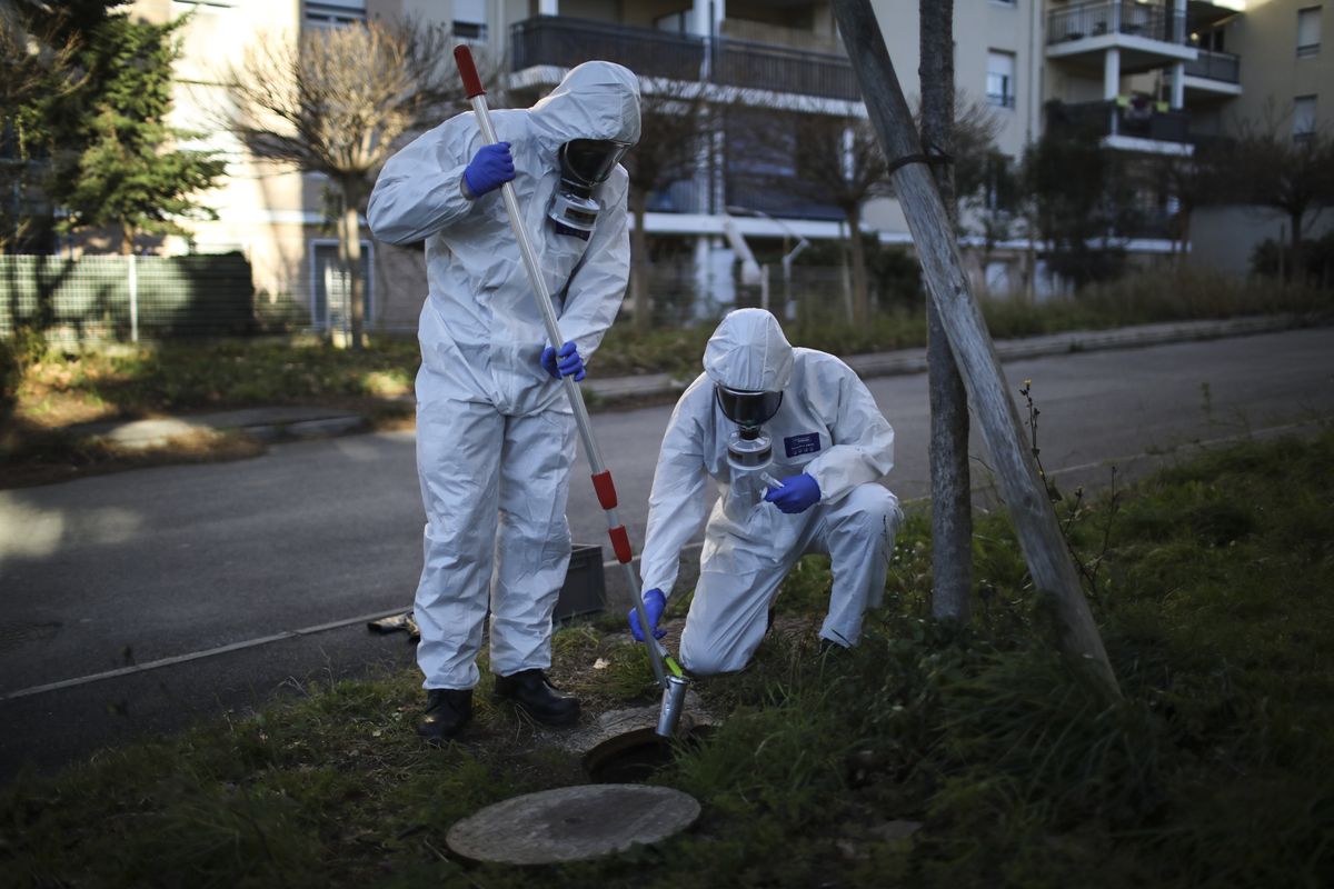Firefighters from the Marins-Pompiers of Marseilles extract samples of sewage water on Jan. 14 at a retirement home in Marseilles southern France.  (Daniel Cole)