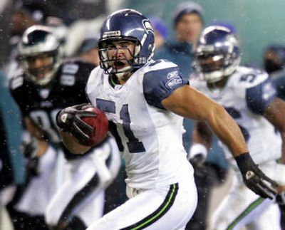 
Rookie middle linebacker Lofa Tatupu, returning an interception for a TD against Philadelphia, is one of Seattle's young defensive players who have stepped up.  
 (Associated Press / The Spokesman-Review)