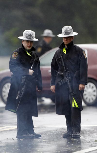 Pennsylvania State Police troopers man a roadblock Sunday in Furlong, Pa., during the hunt for Leonard Egland, 37. (Associated Press)