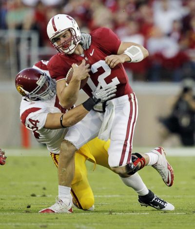USC linebacker Chris Galippo corrals Stanford quarterback Andrew Luck on Saturday. (Associated Press)