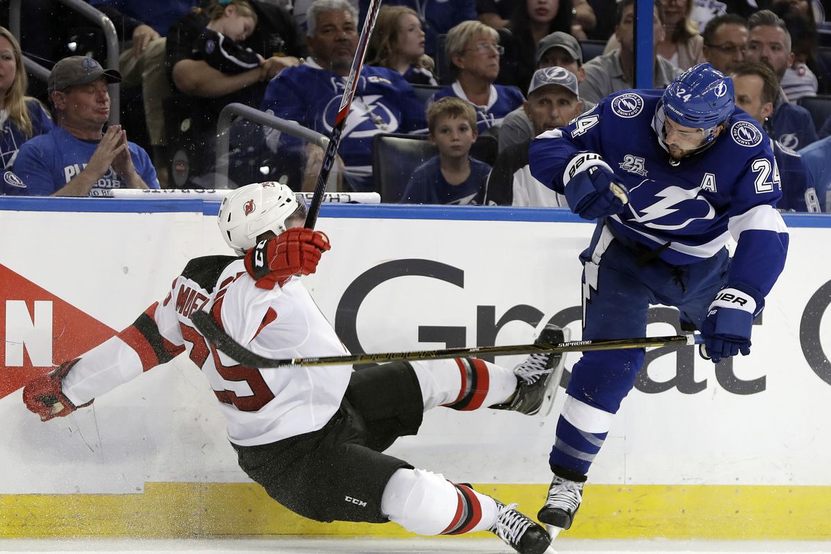 Tampa Bay Lightning right wing Ryan Callahan (24) sends New Jersey Devils defenseman Mirco Mueller flying with a check during the second period of Game 5 of an NHL first-round hockey playoff series Saturday, April 21, 2018, in Tampa, Fla. (Chris O’Meara / Associated Press)