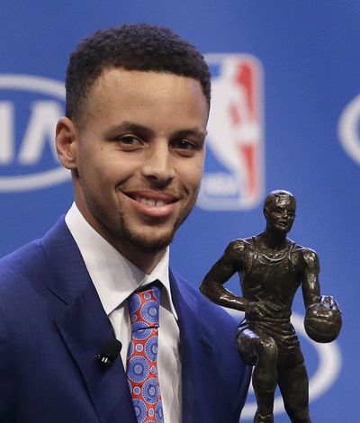 Golden State Warriors guard Stephen Curry is presented with the NBA's Most Valuable Player award Tuesday in Oakland, Calif. Curry is the first unanimous NBA MVP, earning the award for the second straight season. (Ben Margot / Associated Press)