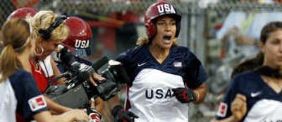 
USA's Tairia Flowers, center, celebrates her solo home run in the second inning. Associated Press
 (Associated Press / The Spokesman-Review)