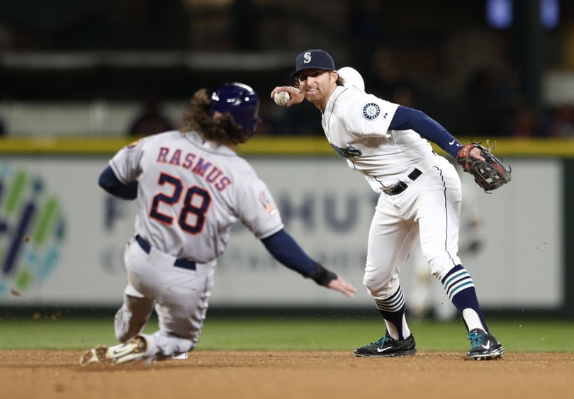 Mariners shortstop Brad Miller, right, completes the double play, getting Houston’s Colby Rasmus out at second during the seventh inning Wednesday. (Associated Press)