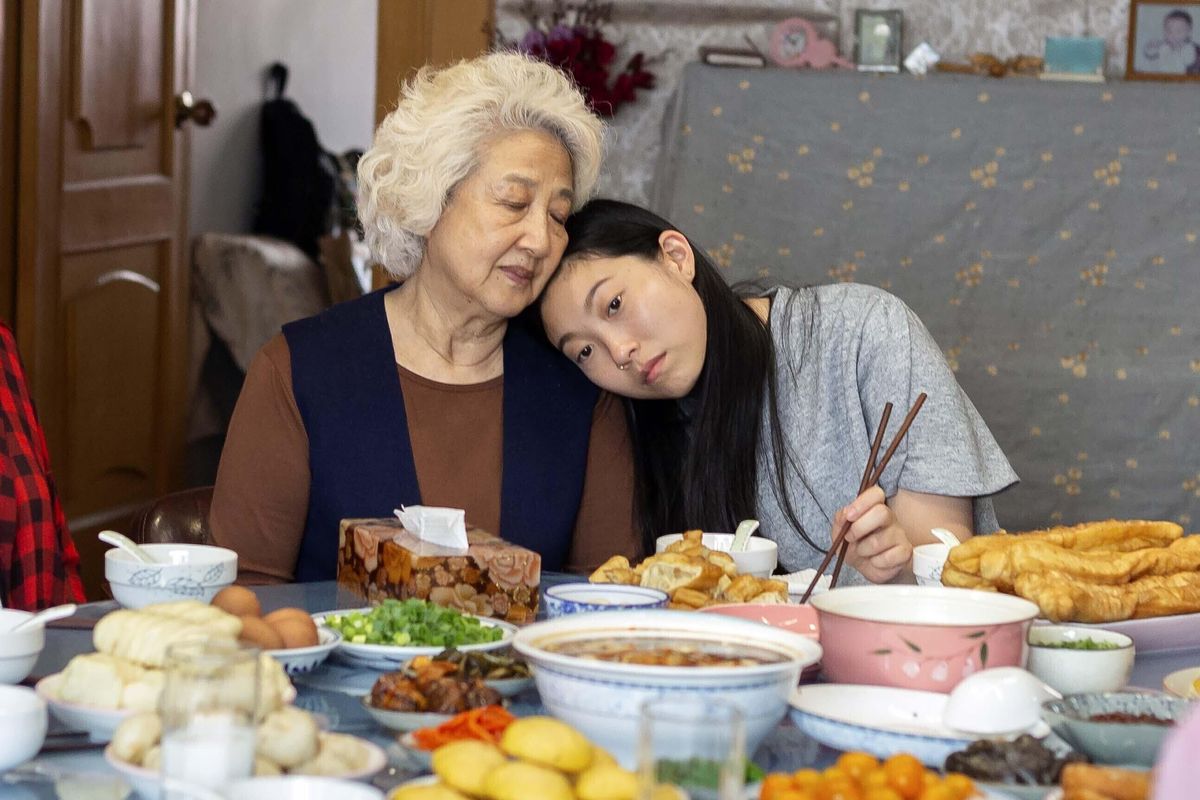Zhao Shuzhen and Awkwafina appear in a scene from “The Farewell.” Awkwafina is nominated for a Golden Globe for best actress in a motion picture comedy for her role in the film. (Casi Moss / AP)