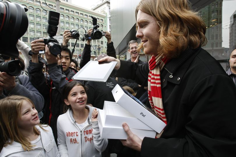 Andres Schobel shows off his new iPad as one of the first customers to buy an iPad on the first day of Apple iPad sales at an Apple Store in San Francisco, Saturday, April 3, 2010. (Paul Sakuma / Associated Press)