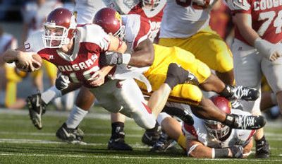 
Washington State quarterback Alex Brink strains away from the Southern California defense and dives for a few extra yards during Saturday's Pac-10 game in Pullman. 
 (Christopher Anderson / The Spokesman-Review)