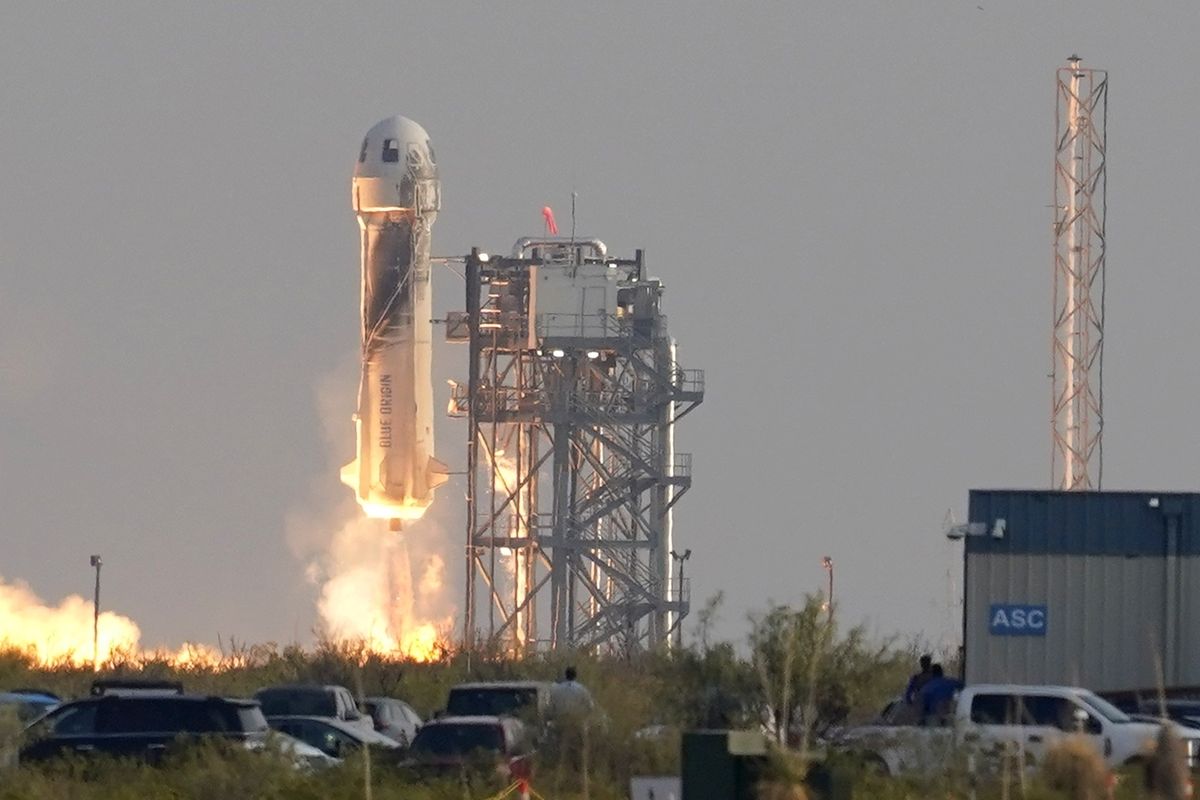 Blue Origin's New Shepard rocket launches carrying passengers Jeff Bezos, founder of Amazon and space tourism company Blue Origin, brother Mark Bezos, Oliver Daemen and Wally Funk, from its spaceport near Van Horn, Texas, Tuesday, July 20, 2021.  (Tony Gutierrez)