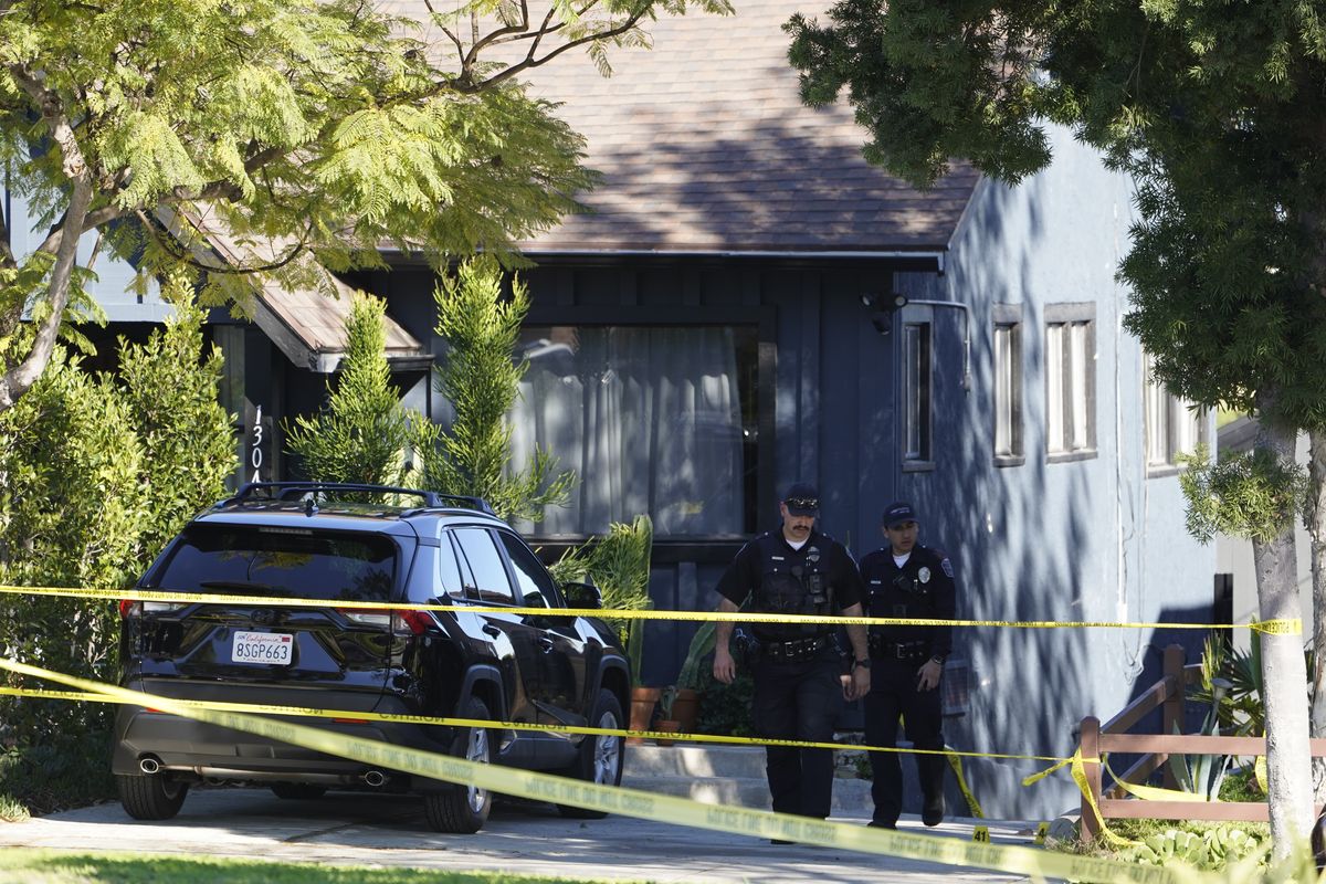 Police investigators leave a crime scene at a home in Inglewood, Calif., on Sunday, Jan. 23, 2022. Authorities said several were killed when multiple shooters opened fire at a house party near Los Angeles early Sunday.  (Damian Dovarganes)