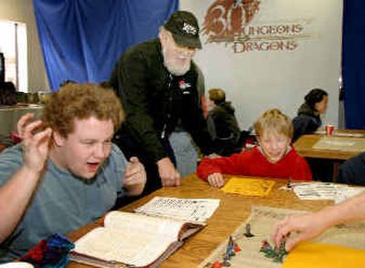 
Taylor Babcock, left, reacts after rolling the dice while playing Dungeons & Dragons in Falcon Heights, Minn., Saturday as the game's creator Dave Arneson, center, and Alex Mears-Freeman, look on. 
 (Associated Press / The Spokesman-Review)