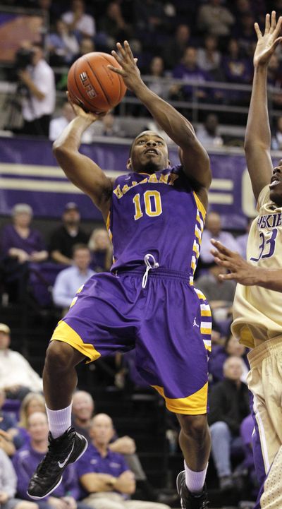 Albany’s Mike Black takes aim for two of his game-high 22 points against Washington on Tuesday. (Associated Press)