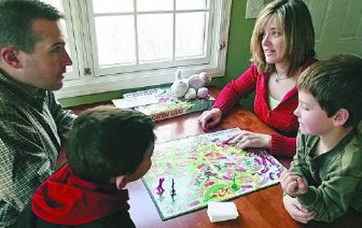 
Kirsten and Clay Whipple play a  game with their  sons, Chase, 8, right, and Jack, 4, at their home in Northbrook, Ill. The Whipples use rewards to get their sons to behave. 
 (Associated Press / The Spokesman-Review)