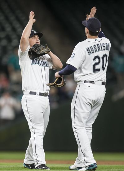 Kyle Seager, left, and Logan Morrison celebrate a Mariners’ victory. (Associated Press)