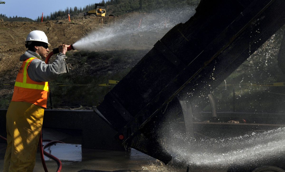 Jamere Radford, of North Wind Construction, washes trucks May 21 at the hazardous waste repository in Kellogg. The effort to clean up the 21-square-mile Bunker Hill Superfund site, contaminated by lead from Silver Valley mining, is among projects in the Inland Northwest to benefit from federal stimulus money.  kathypl@spokesman.com (Photos by Kathy Plonka kathypl@spokesman.com / The Spokesman-Review)