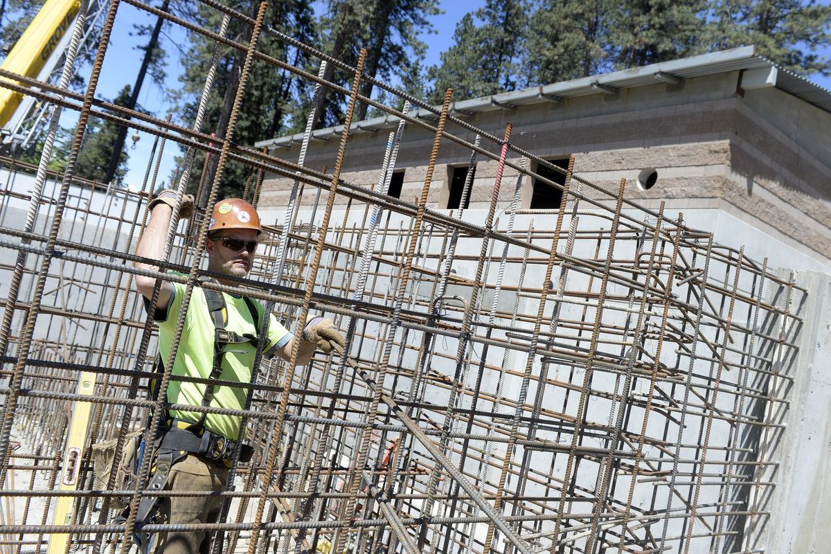 Doug Schoene of Rainier Steel calls for more reinforcing rod for one of the giant tanks under construction in the new advanced treatment facility at the Coeur d’Alene Wastewater Treatment Plant on Wednesday. (Jesse Tinsley)