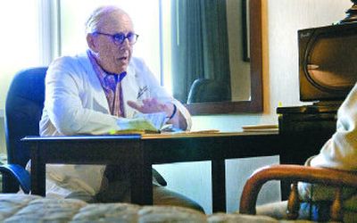 
Dr. Thomas Orvald, a Yakima heart surgeon with The Hemp and Cannabis Foundation talks with a client about lower back pain from a work related injury Wednesday. The foundation has been holding meetings in Spokane for the past 18 months to help people obtain marijuana legally for medical reasons. 
 (Christopher Anderson / The Spokesman-Review)