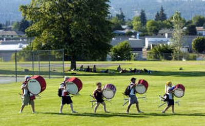 
The drum line walks in formation to their practice area after dinner.
 (Dan Pelle / The Spokesman-Review)