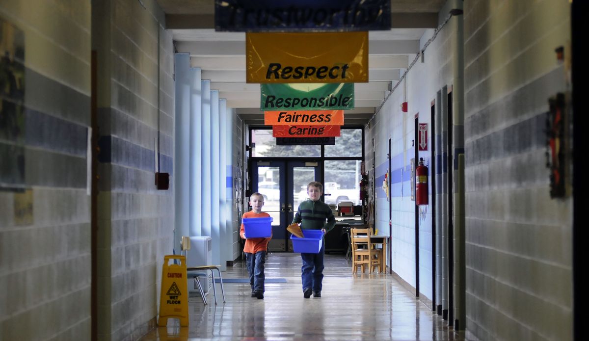 Medical Lake Elementary School third-graders Mason Hester, left, and Hunter Zepp perform recycling duties Dec. 17. (Dan Pelle)