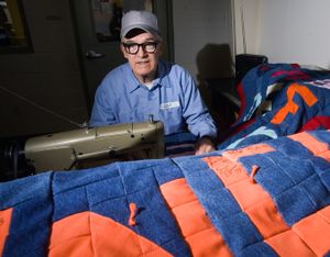 In this March 17, 2010 photo, John Gout, a 70-year-old inmate at South Idaho Correctional Institution in Boise, Idaho works on a quilt. Some years ago, an officer suggested that Gout might like to make a quilt that could be auctioned for a fundraiser. Since then, he has made more than 30 quilts for local charities. Everything he makes comes from scraps and donated fabric and works in the laundry room at the prison. (Shawn Raecke / The Idaho Statesman)